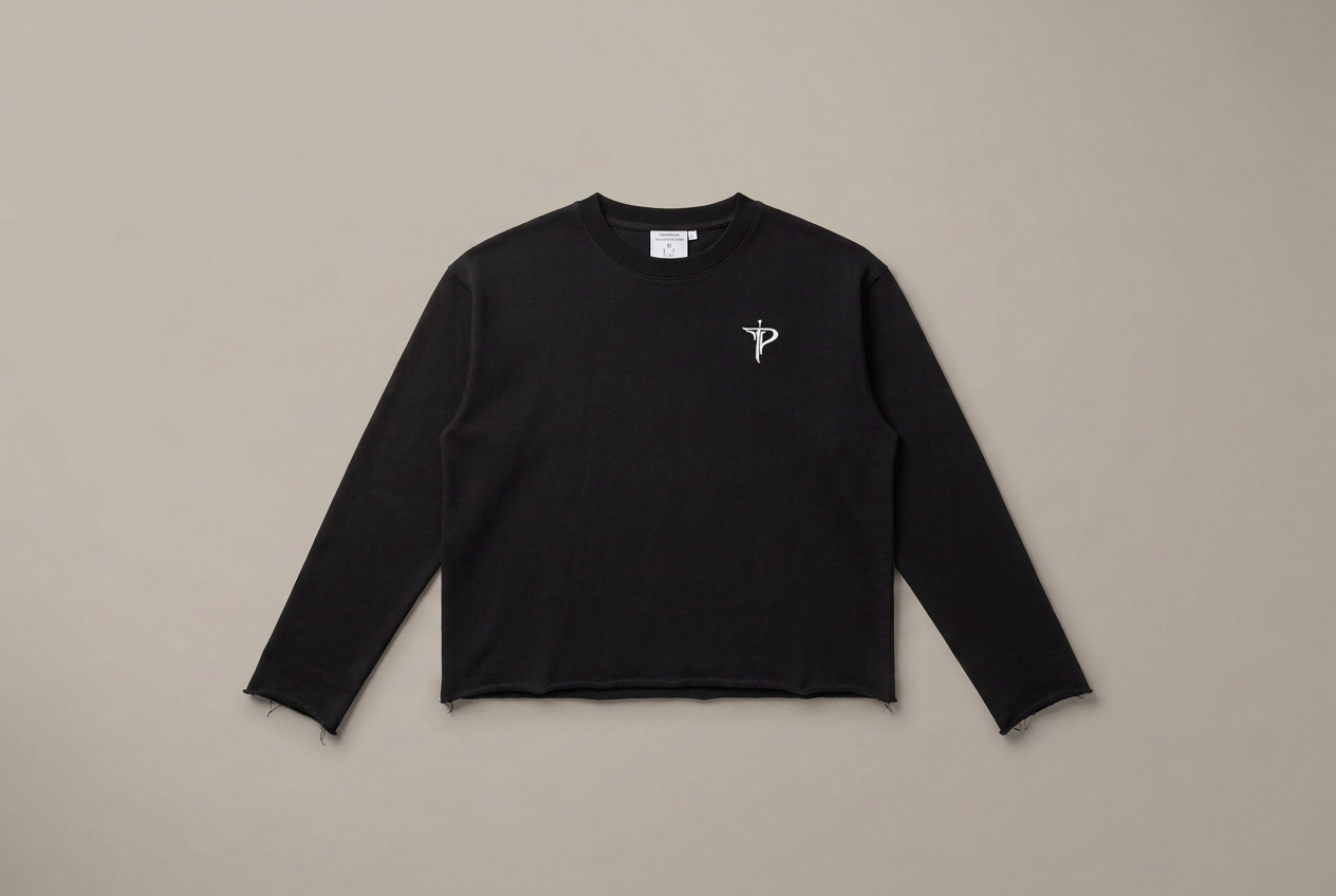 Front of the Tutto Passa knit in black with embroidered chest emblem